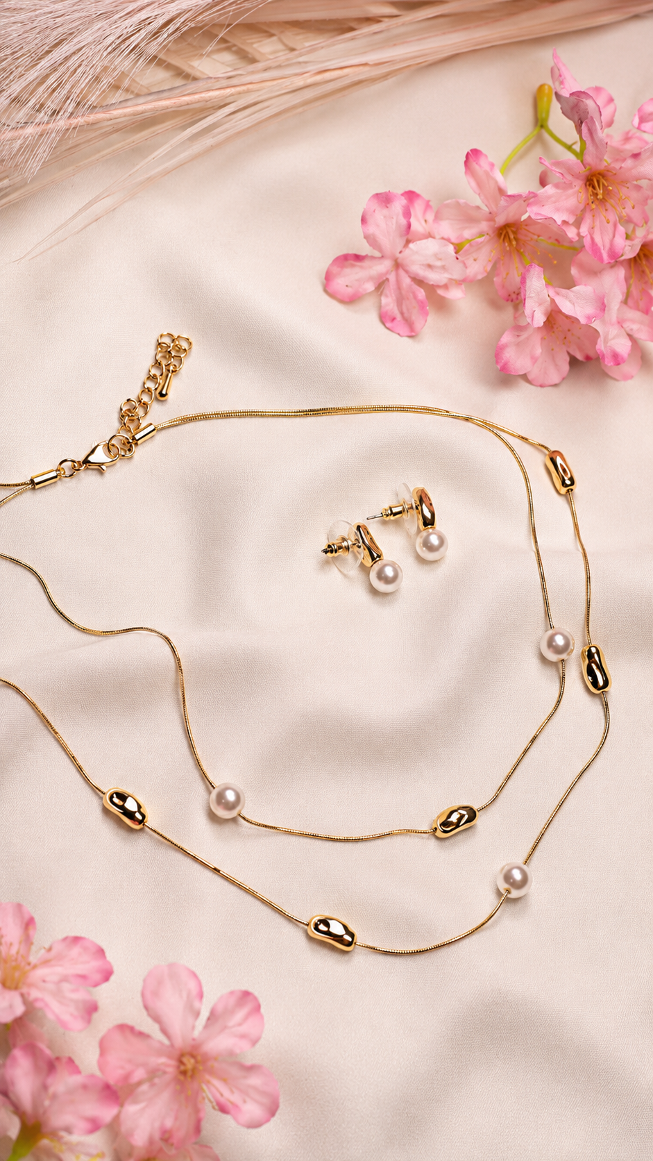 A Gold Necklace With Small White Pearls