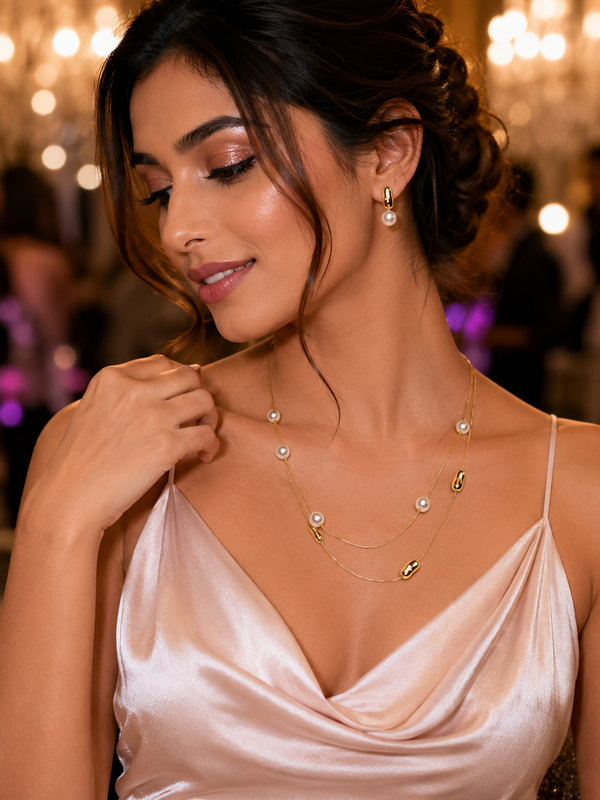 A Gold Necklace With Small White Pearls