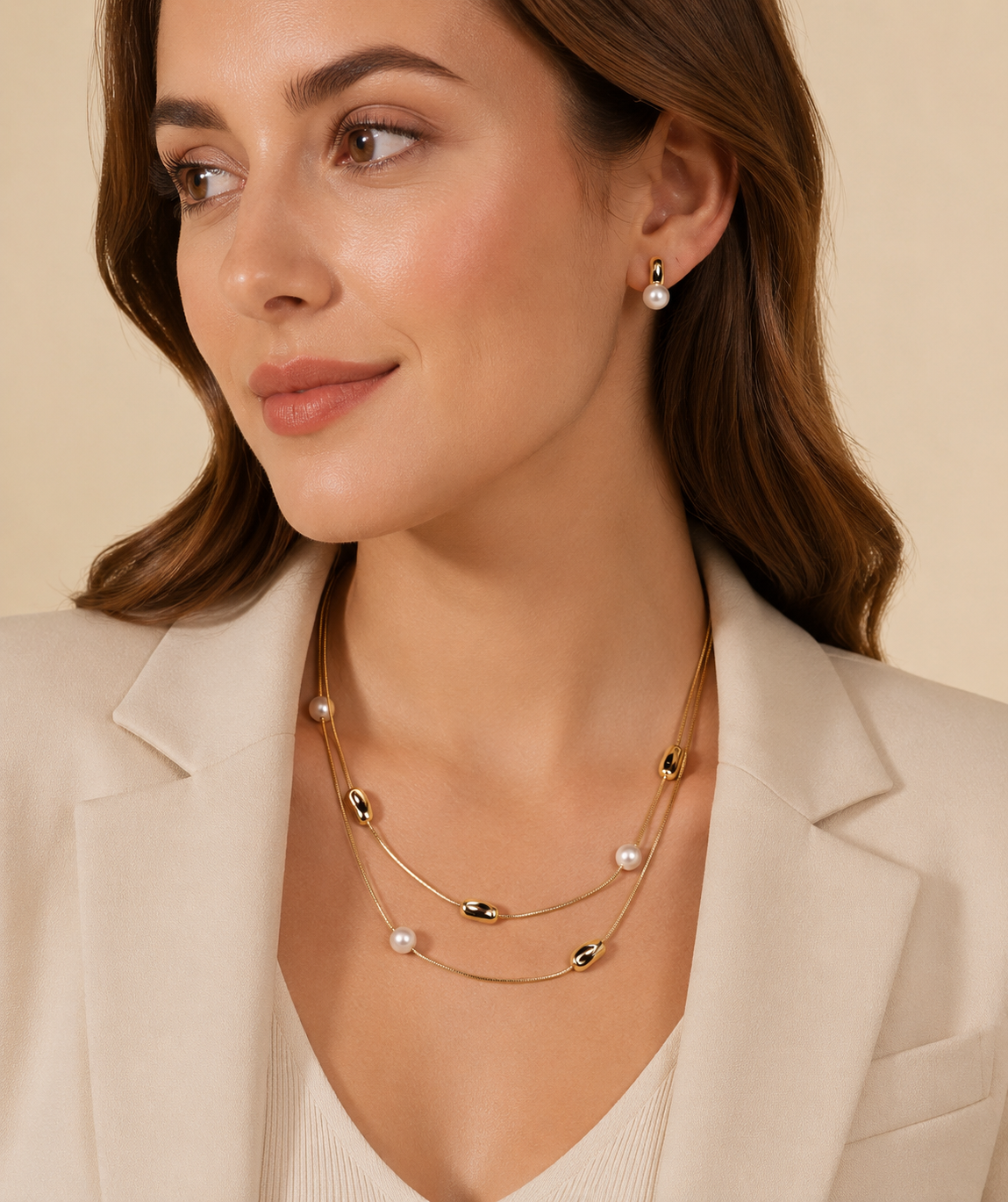 A Gold Necklace With Small White Pearls